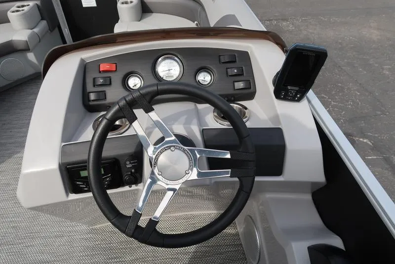 Slide: The Image of 2024 Bennington 22 SXSR boat dashboard with steering wheel and gauges. - 17