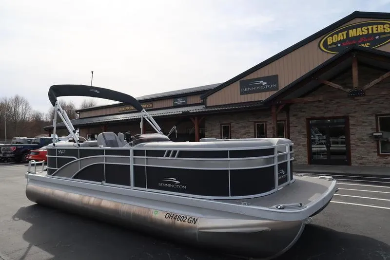 Slide: The Image of 2024 Bennington 22 SXSR pontoon boat parked outside dealership. - 3