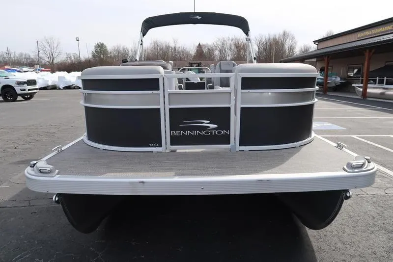 Slide: The Image of 2024 Bennington 22 SXSR pontoon boat, rear view in a parking lot. - 4