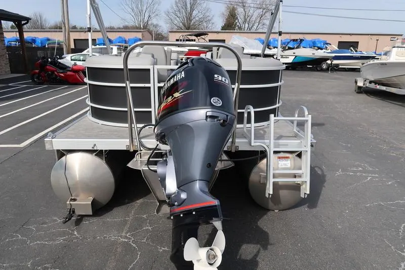 Slide: The Image of 2024 Bennington 22 SXSR pontoon boat with Yamaha 90 engine, parked in a lot. - 6