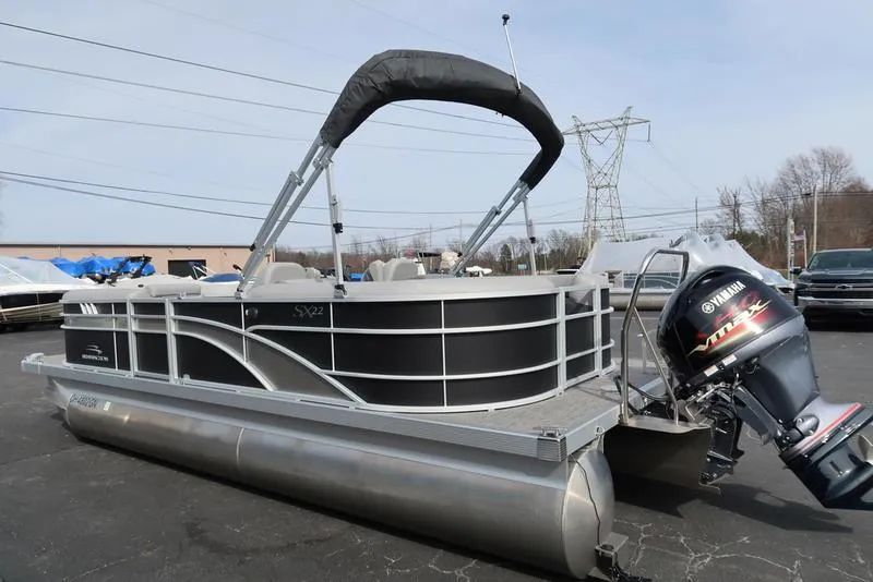 Slide: The Image of 2024 Bennington 22 SXSR pontoon boat with Yamaha outboard motor, parked outdoors. - 7