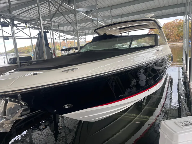 Slide: The Image of 2022 Sea Ray 400 SLX boat docked under a covered marina. - 10