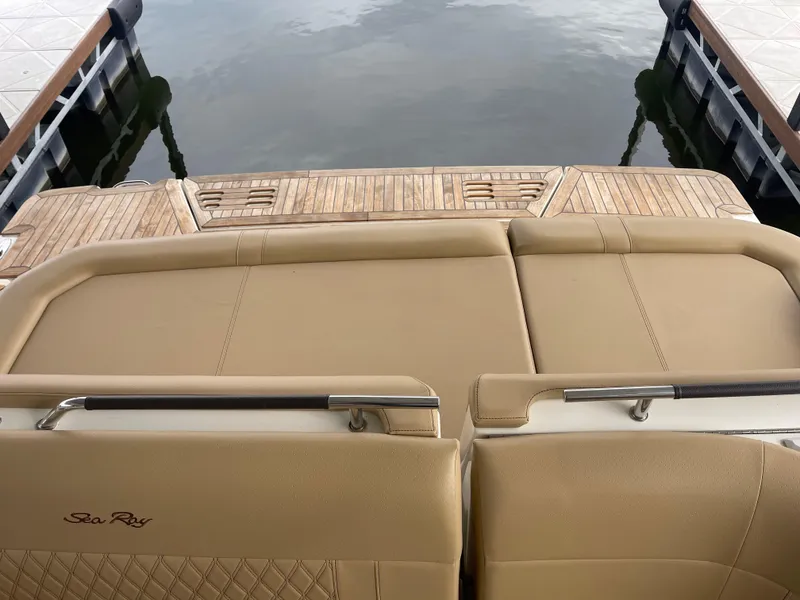 Slide: The Image of 2022 Sea Ray 400 SLX boat with tan seating and wooden deck at a dock. - 13