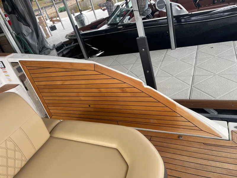 Slide: The Image of 2022 Sea Ray 400 SLX boat interior with tan seating and wooden paneling. - 15