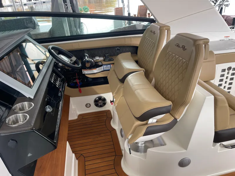 Slide: The Image of Interior of 2022 Sea Ray 400 SLX boat with tan leather seats and modern dashboard. - 21