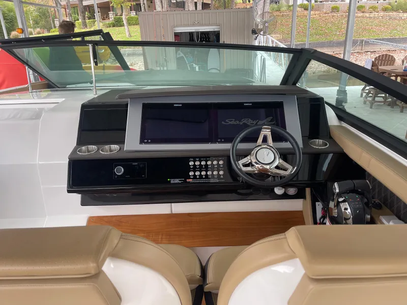 Slide: The Image of 2022 Sea Ray 400 SLX helm with modern controls and dual displays. - 22