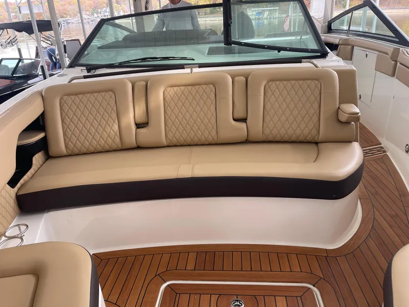 Slide: The Image of Luxurious 2022 Sea Ray 400 SLX boat interior with tan leather seating and wood flooring. - 23
