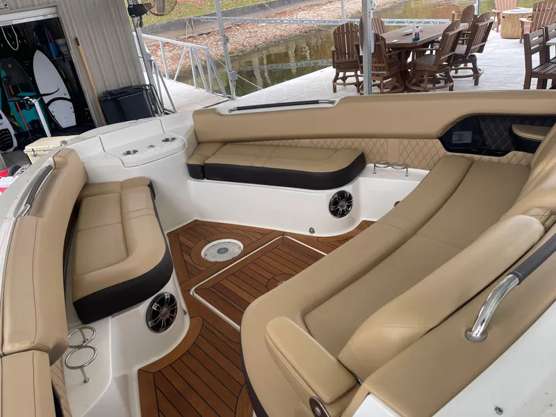 Slide: The Image of Luxurious interior of 2022 Sea Ray 400 SLX boat with tan seating and wood flooring. - 24