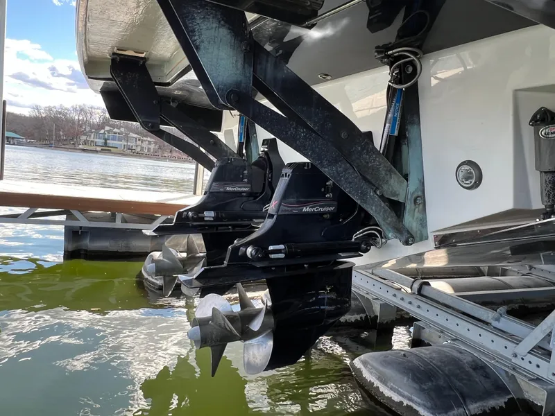 Slide: The Image of 2022 Sea Ray 400 SLX boat with dual MerCruiser engines docked on a lake. - 28