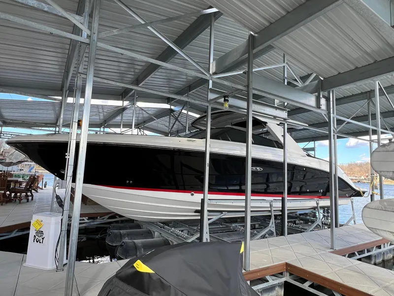 Slide: The Image of 2022 Sea Ray 400 SLX boat docked in a covered marina. - 6