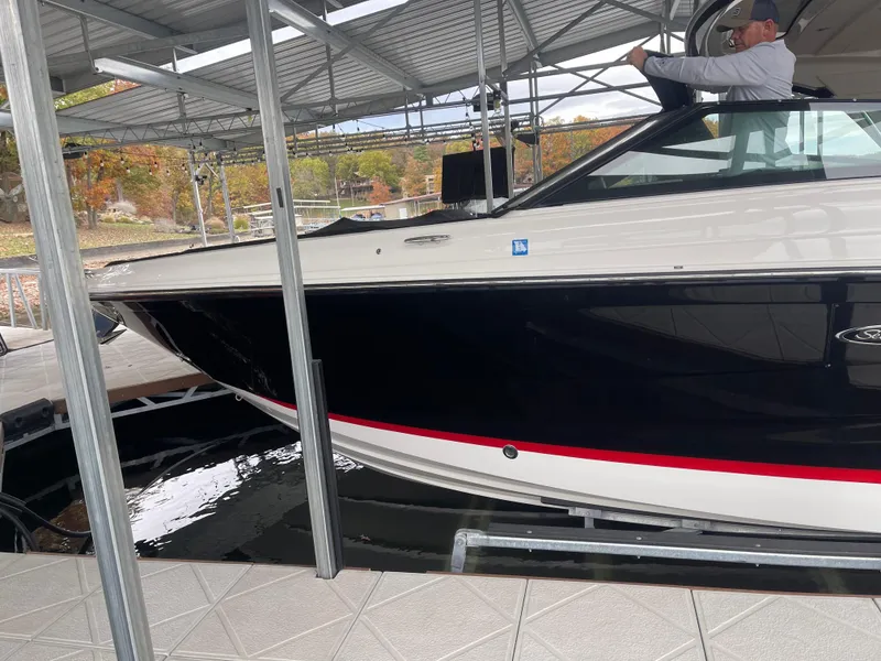 Slide: The Image of 2022 Sea Ray 400 SLX boat docked under a covered marina. - 9