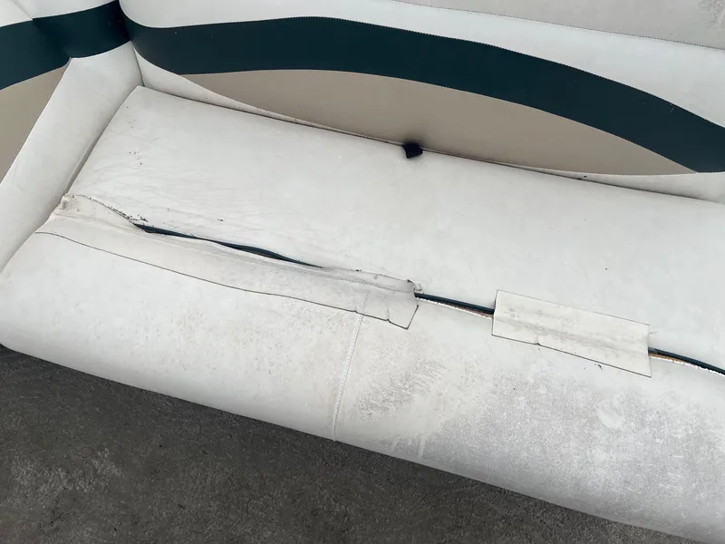 Slide: The Image of Torn upholstery on a 2009 Bentley Pontoons 244 4-point boat seat. - 10