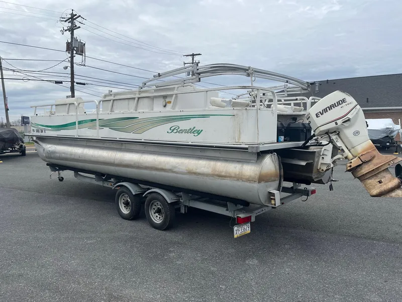 Slide: The Image of 2009 Bentley Pontoons 244 4-point boat on trailer with Evinrude motor. - 2