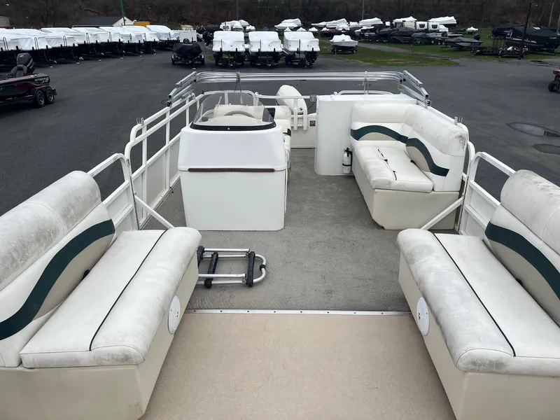 Slide: The Image of 2009 Bentley Pontoons 244 4-point boat with spacious seating, docked in a marina. - 8