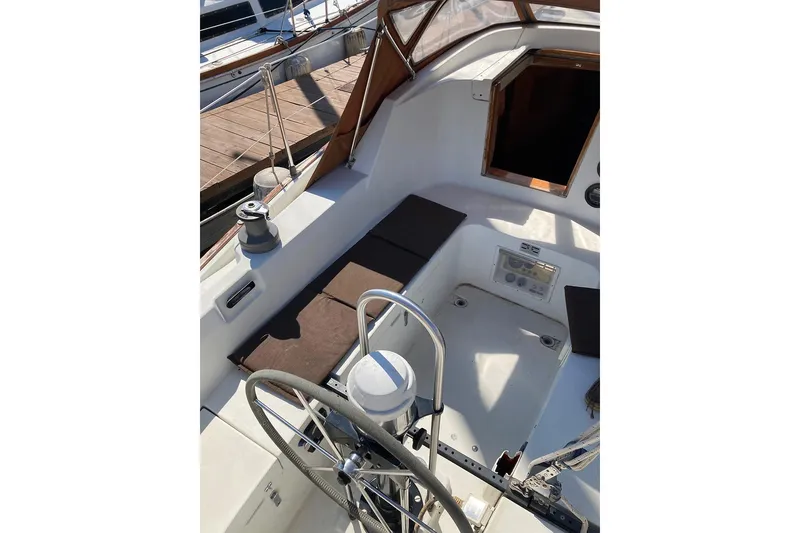 Slide: The Image of 1981 C&C Landfall 35 sailboat cockpit with steering wheel and seating. - 10