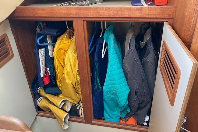 Slide: The Image of Cabinet with colorful jackets and boots inside a 1981 C&C Landfall 35 sailboat. - 12
