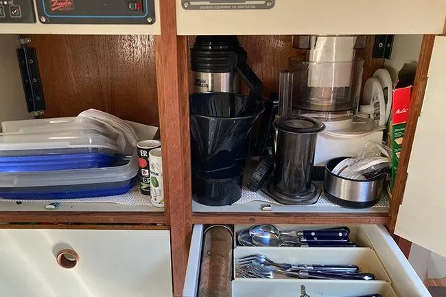 Slide: The Image of Cabinet interior of 1981 C&C Landfall 35 yacht with kitchenware and utensils. - 13