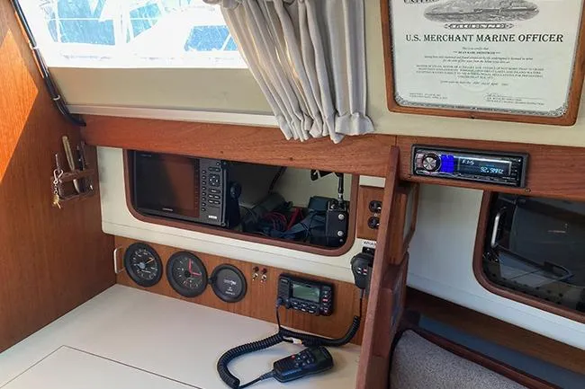 Slide: The Image of 1981 C&C Landfall 35 yacht interior with navigation equipment and marine certificate. - 20