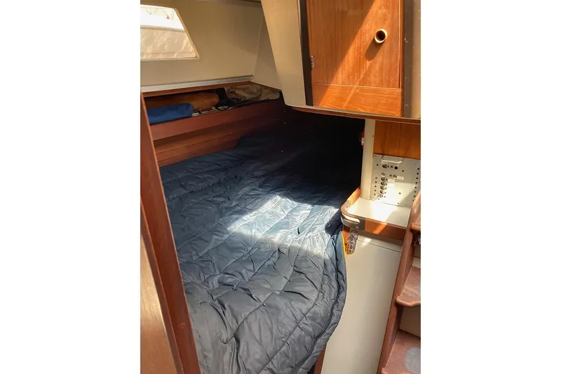 Slide: The Image of Cozy cabin interior of 1981 C&C Landfall 35 sailboat with bed and wooden cabinetry. - 25