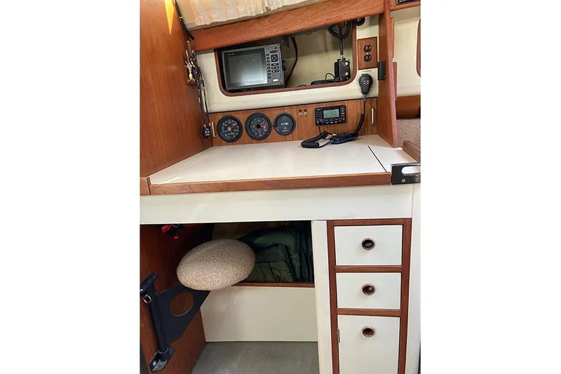Slide: The Image of 1981 C&C Landfall 35 navigation station with instruments and storage drawers. - 26