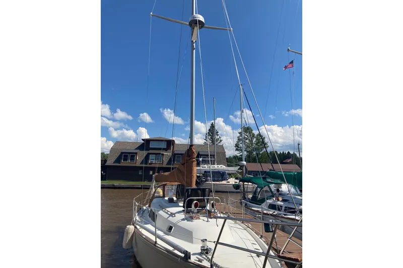 Slide: The Image of 1981 C&C Landfall 35 sailboat docked under a clear blue sky. - 38
