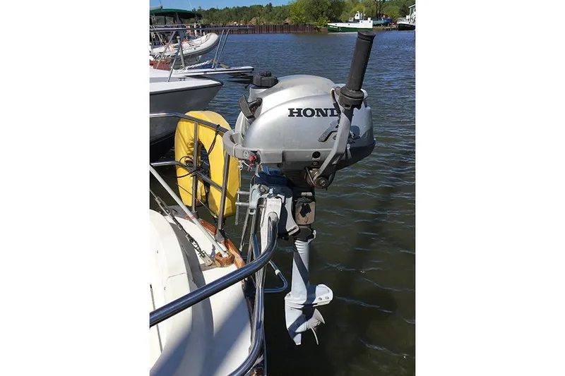 Slide: The Image of Outboard motor on 1981 C&C Landfall 35 sailboat, docked by the water. - 5