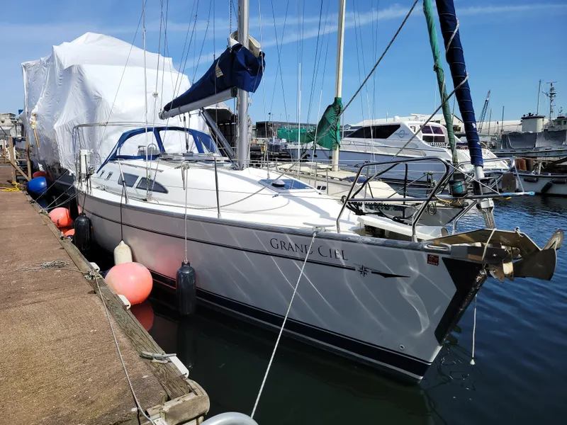 Slide: The Image of 2001 Jeanneau Sun Odyssey 37 sailboat docked at marina, clear sky, calm water. - 1