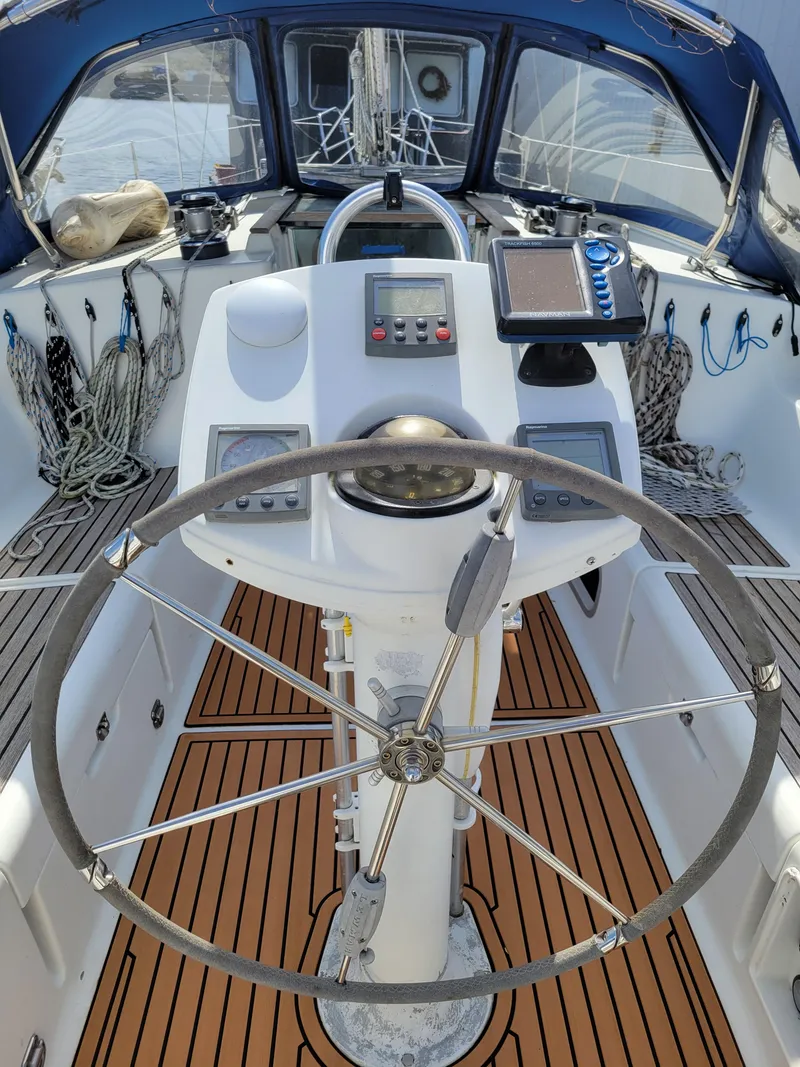 Slide: The Image of Cockpit of 2001 Jeanneau Sun Odyssey 37 sailboat with steering wheel and navigation instruments. - 11