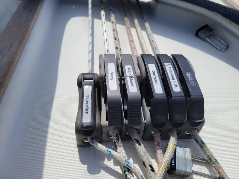 Slide: The Image of Sailing controls on Jeanneau Sun Odyssey 37, 2001 model, featuring labeled rope clutches. - 15