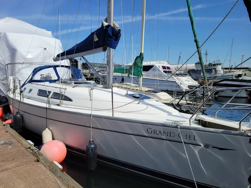 Slide: The Image of 2001 Jeanneau Sun Odyssey 37 sailboat docked at marina, clear sky background. - 2