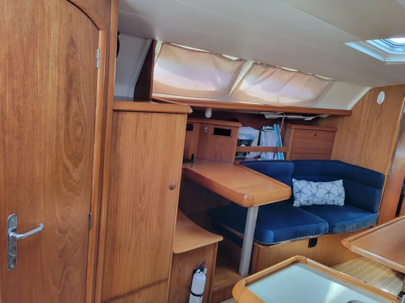 Slide: The Image of Interior of 2001 Jeanneau Sun Odyssey 37 sailboat with wooden finish and blue seating. - 20