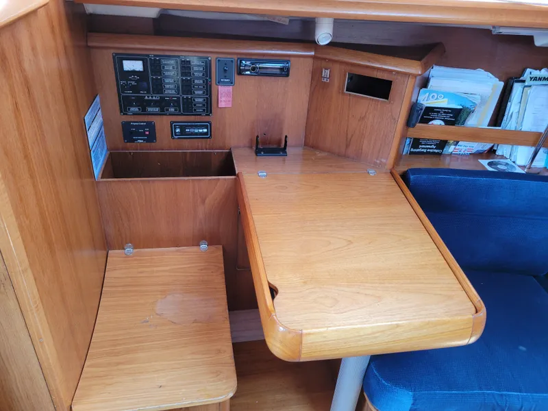 Slide: The Image of Interior of 2001 Jeanneau Sun Odyssey 37 sailboat with navigation station and wooden desk. - 24
