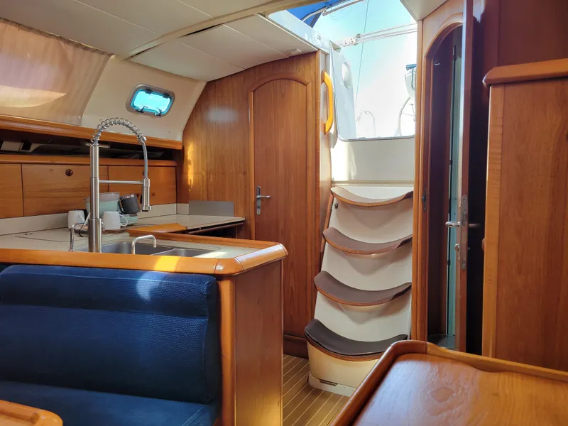 Slide: The Image of Interior of 2001 Jeanneau Sun Odyssey 37 sailboat with wooden finish and compact kitchen. - 26