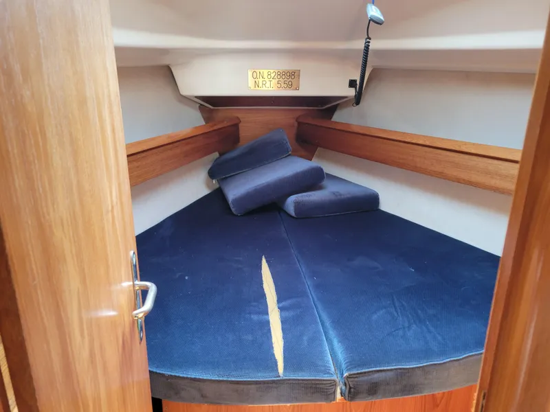 Slide: The Image of Cozy cabin interior of 2001 Jeanneau Sun Odyssey 37 sailboat with blue cushions. - 28