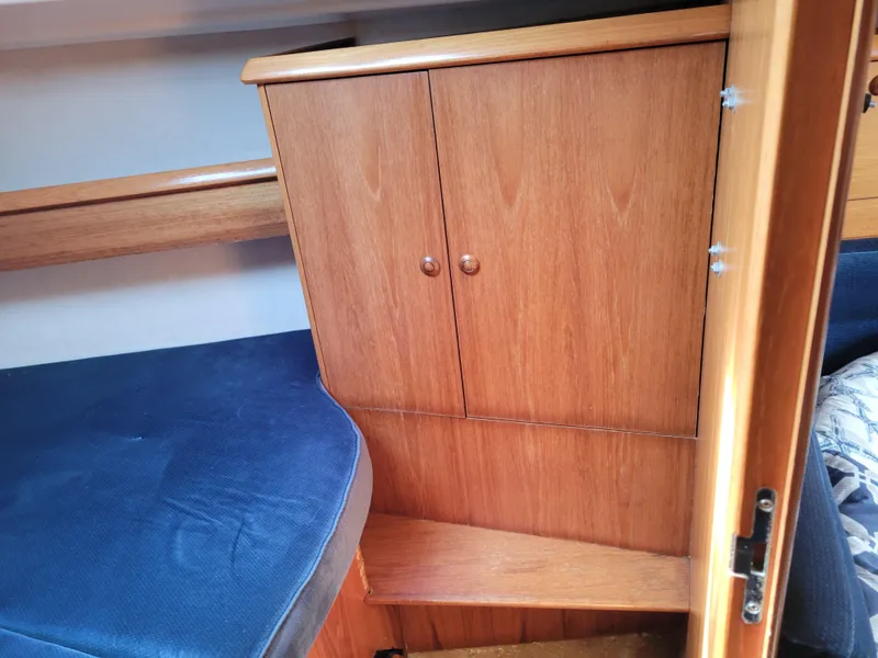 Slide: The Image of Interior of 2001 Jeanneau Sun Odyssey 37 yacht with wooden cabinet and blue seating. - 29