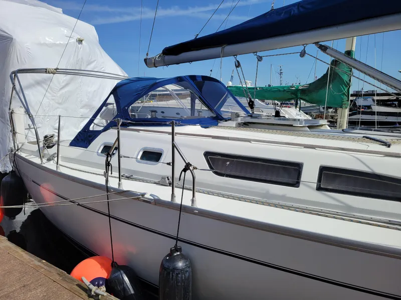 Slide: The Image of Jeanneau Sun Odyssey 37 sailboat, 2001 model, docked with blue canopy and fenders. - 3