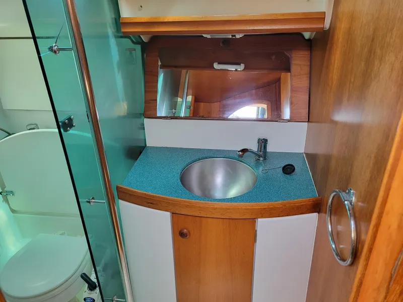 Slide: The Image of Bathroom interior of 2001 Jeanneau Sun Odyssey 37 yacht with sink and mirror. - 32