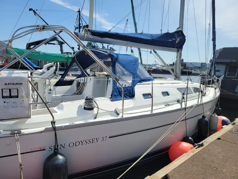 Slide: The Image of Jeanneau Sun Odyssey 37 sailboat, 2001 model, docked at marina under clear sky. - 4
