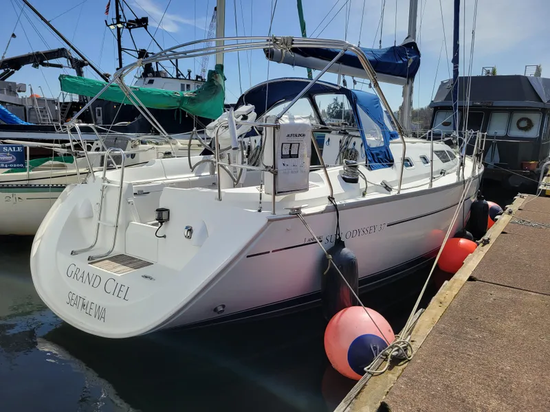 Slide: The Image of 2001 Jeanneau Sun Odyssey 37 sailboat docked with blue canopy and fenders. - 5