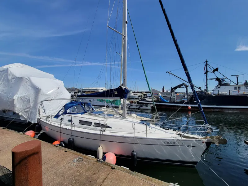 Slide: The Image of 2001 Jeanneau Sun Odyssey 37 sailboat docked at a marina under clear blue skies. - 6