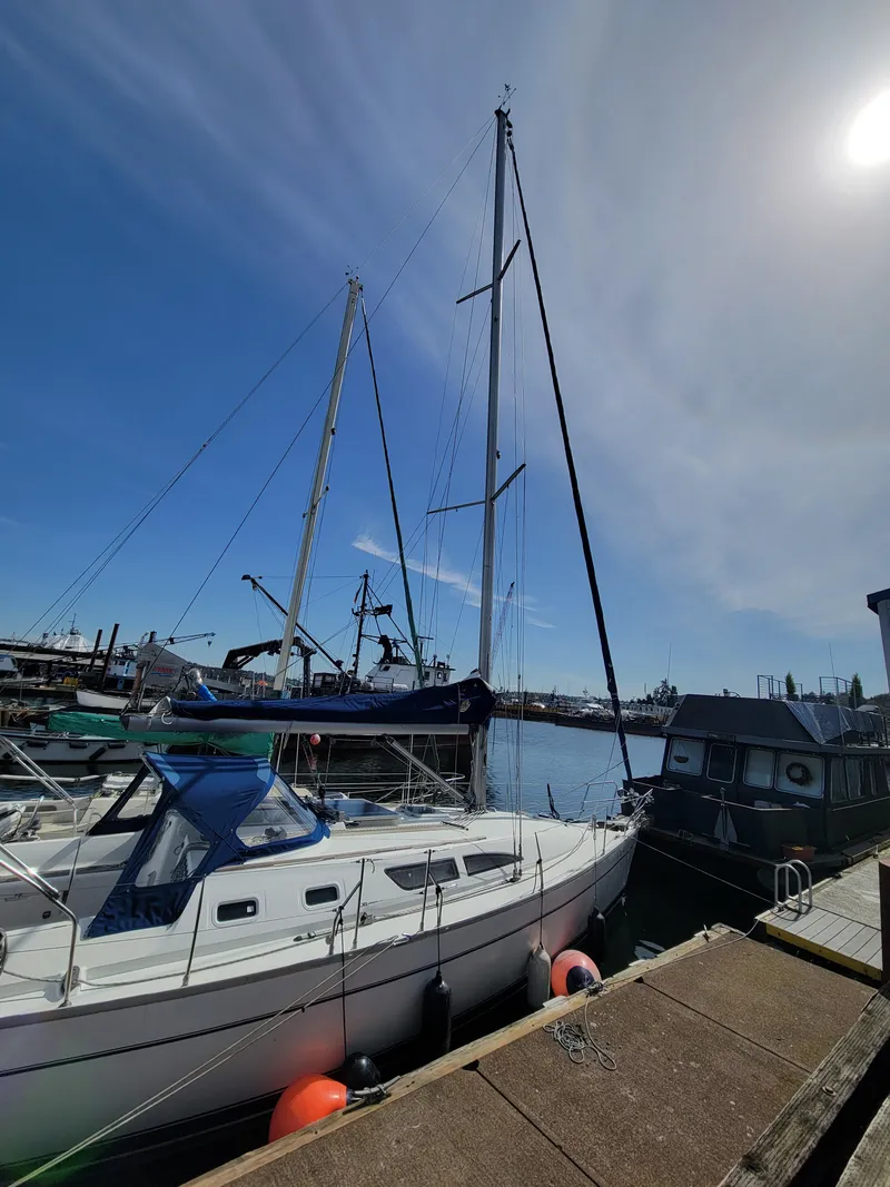 Slide: The Image of 2001 Jeanneau Sun Odyssey 37 sailboat docked under clear blue sky. - 8