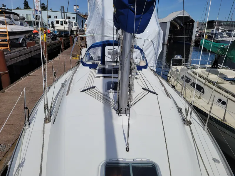 Slide: The Image of 2001 Jeanneau Sun Odyssey 37 sailboat docked at marina, showcasing deck and rigging. - 9