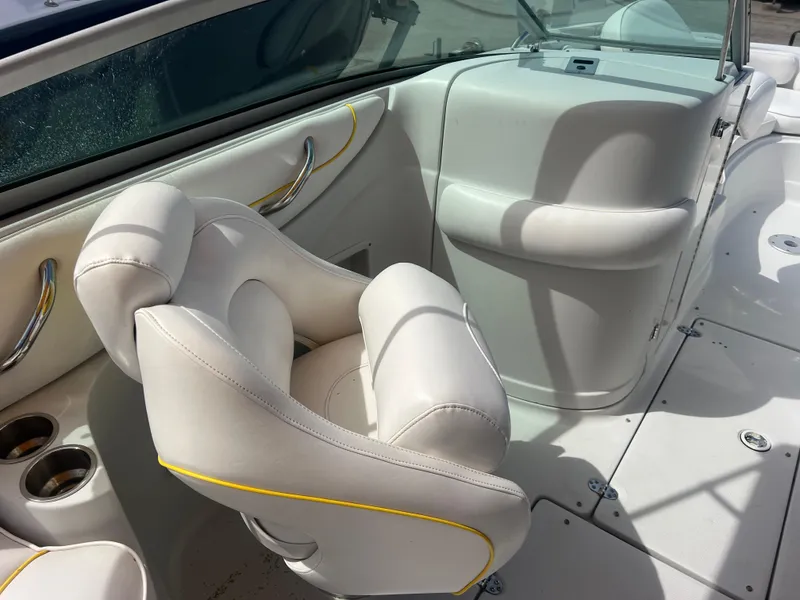 Slide: The Image of 2006 Crownline 240 EX boat interior with white seating and cup holders. - 12