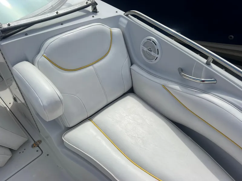 Slide: The Image of 2006 Crownline 240 EX boat interior with white seating and yellow accents. - 15