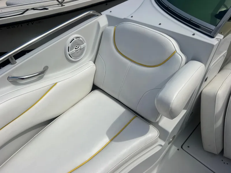 Slide: The Image of 2006 Crownline 240 EX boat interior with white seating and yellow accents. - 16