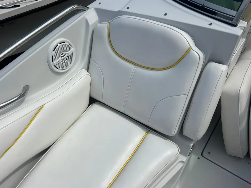 Slide: The Image of 2006 Crownline 240 EX boat interior with white seating and yellow accents. - 17