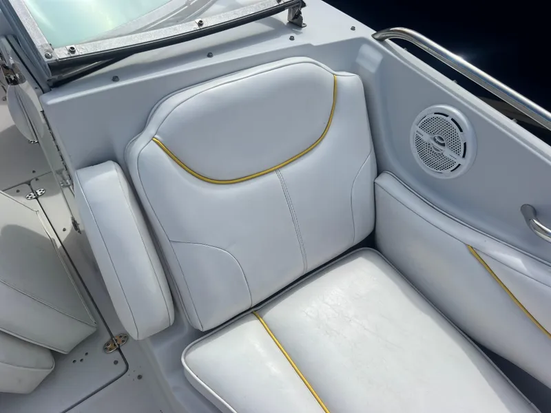 Slide: The Image of 2006 Crownline 240 EX boat interior with white seating and speaker. - 18