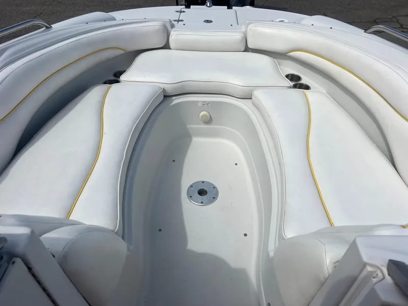 Slide: The Image of 2006 Crownline 240 EX boat interior with white cushioned seating and yellow accents. - 19