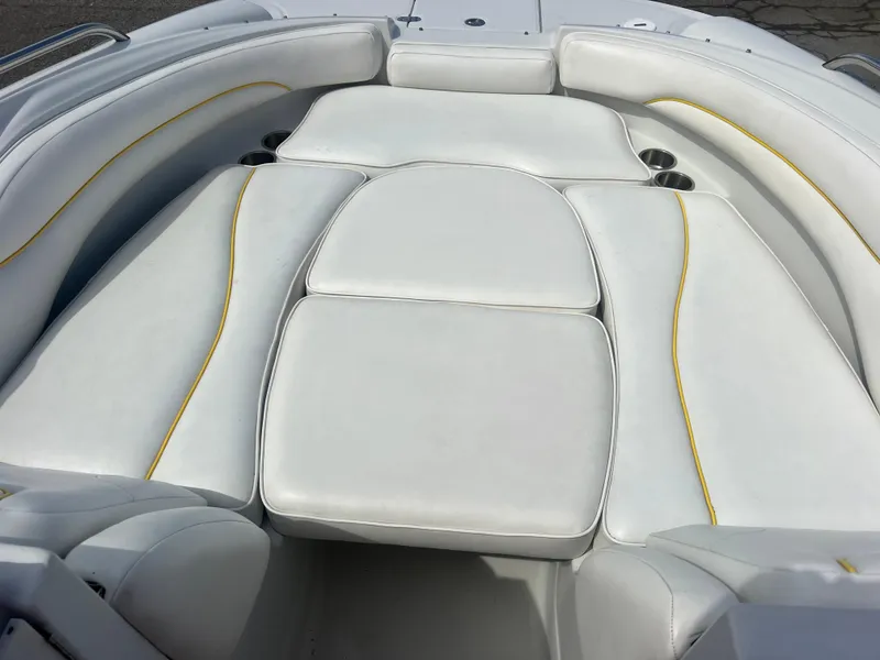 Slide: The Image of 2006 Crownline 240 EX boat interior with white cushioned seating and yellow trim. - 20