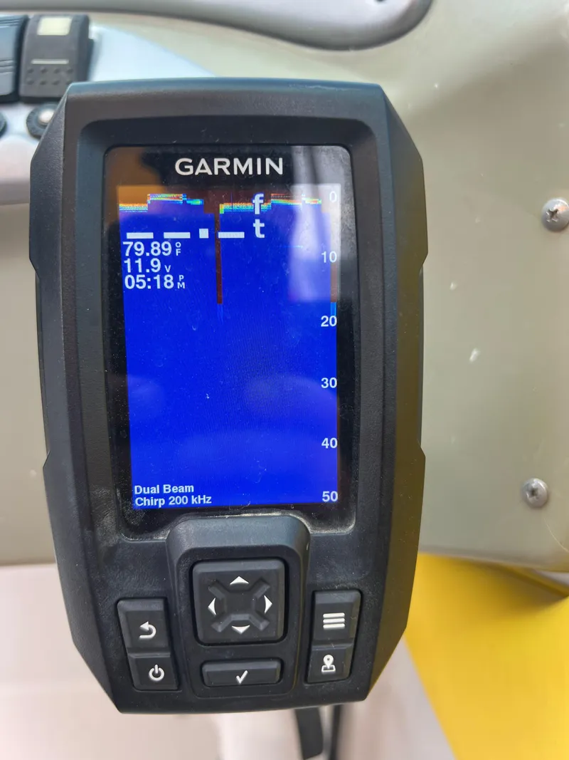 Slide: The Image of Garmin fishfinder on 2006 Crownline 240 EX boat displaying water temperature and depth. - 21